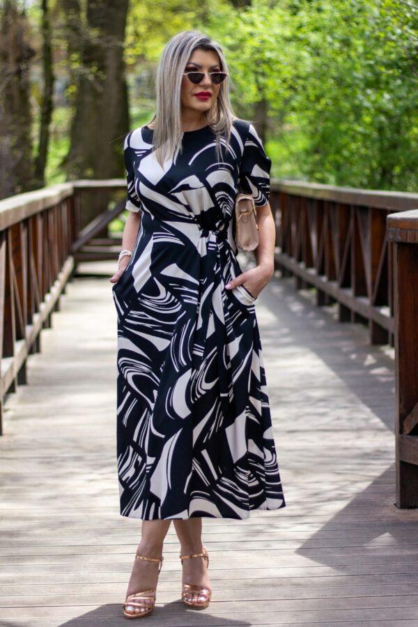 Czarno-beżowa sukienka do połowy łydki z wiązaniem z boku